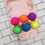 Light pink egg carton with 6 brightly coloured egg shaped bath bombs